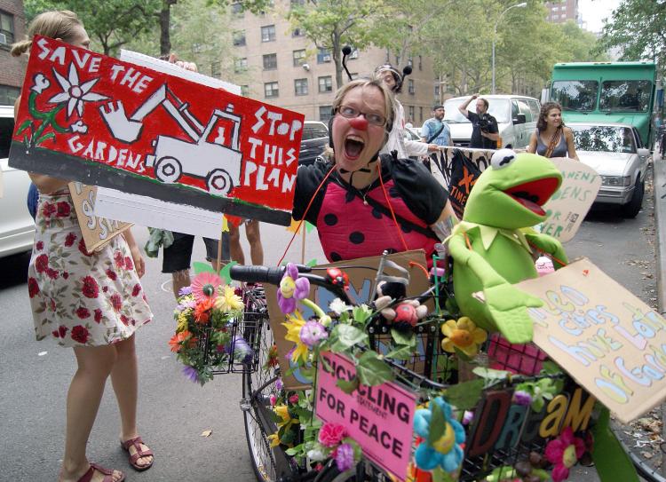 LADY BUG: Community garden supporters participated at a rally in Chelsea on Tuesday. An agreement to protect over 300 community gardens in New York City is set to expire in September.