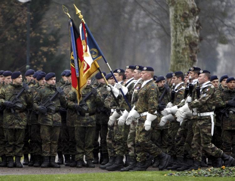 COOPERATIVE SERVICE: German and French troops parade during a ceremony in the eastern French city of Strasbourg on Dec. 10, to mark the deployment of the first German combat unit to be stationed in France since the end of World War II. (Christian Lutz/AFP/Getty Images)