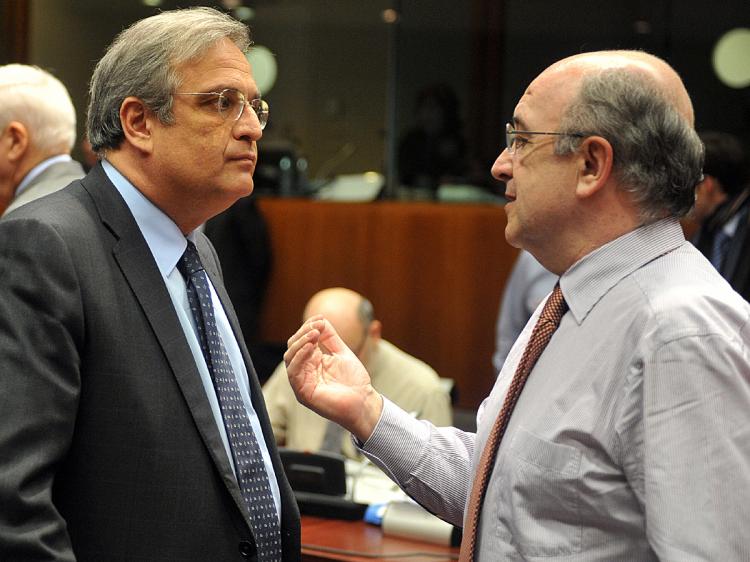 Greek Finance Minister Ioannis Papathanasiou (L) talks with EU economic and monetary affairs commissioner Joaquin Almunia during an economy and finance ministers meeting at EU headquarters in Brussels.    (Dominique Faget/AFP/Getty Images)