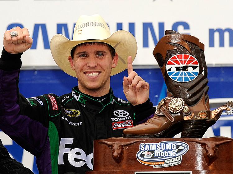 Denny Hamlin celebrates in victory lane after winning the NASCAR Sprint Cup Series Samsung Mobile 500 at Texas Motor Speedway. (Rusty Jarrett/Getty Images for NASCAR)