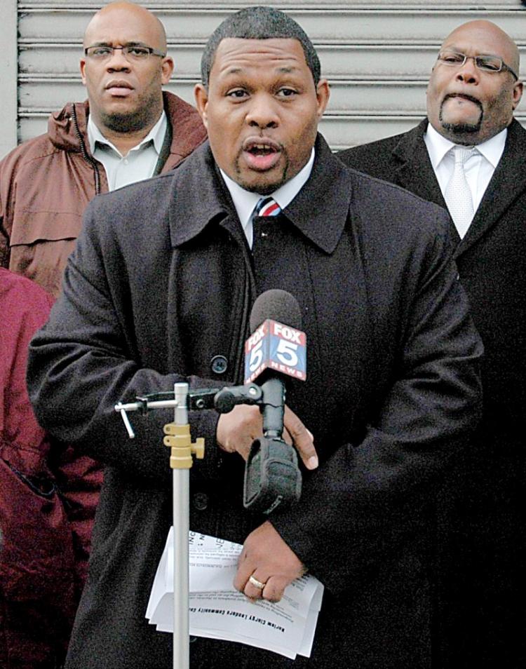 Carlton Berkley, of 100 Blacks In Law Enforcement Who Care, offers to broker a peace treaty between two groups fighting each other in Harlem. (R) Alex Williams, community activist and campaign treasurer for Berkley. (L) Pastor Erik Crumblie, campaign mana (Jonathan Weeks/Epoch Times)