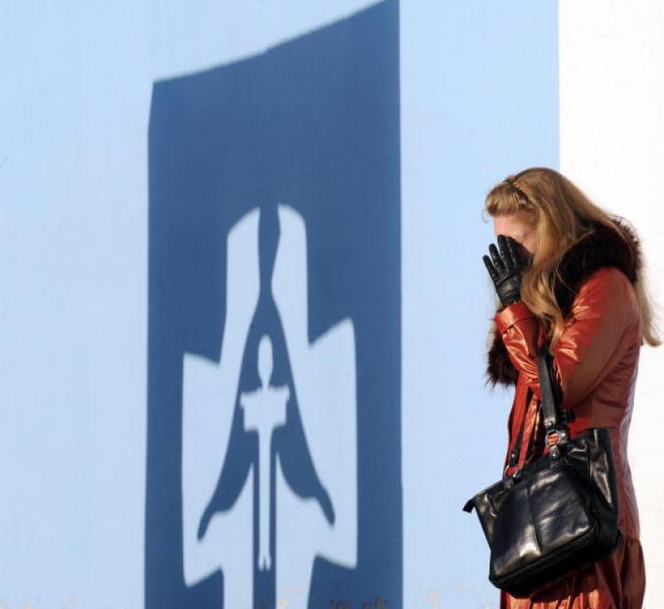 A woman cries as she visits the Holodomor Memorial on a sunny warm day in Kiev on November 11, 2008.  (Sergei Supinsky/AFP/Getty Images)