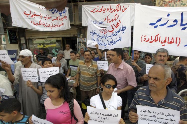 Dozens of Iraqis demonstrate in Baghdad on June 19 against power rationing. A spokesman for the Basra Provincial Council in the southern city of Basra said that residents receive around two hours of electricity for every five hours that it is turned off. Temperatures in the city reach over 120 degrees Fahrenheit and thousands of Basra residents came out to protest the rationing Saturday. (Ali Al-Saadi/AFP/Getty Images)