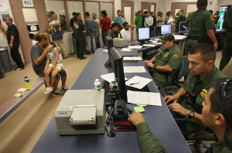 A mother and daughter, caught after illegally crossing into the United States, await deportation to Mexico, as Border Patrol agents out-process illegal aliens at a station August 7, 2008 in Laredo, Texas. Arizona recently passed a bill that would make ill (John Moore/Getty Images)