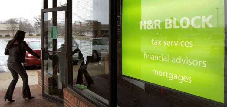 A woman enters an H&R Block facility in Mount Prospect, Illinois. The U.S. Internal Revenue Service (IRS) will require, for the first time, tax-preparation companies to register and pay a fee. (Tim Boyle/Getty Images)