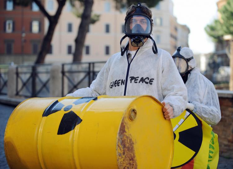 Greenpeace activists carry fake radioactive waste bins during a protest against nuclear power in the center of Rome on March 7, 2009. (Tiziana Fabi/AFP/Getty Images)