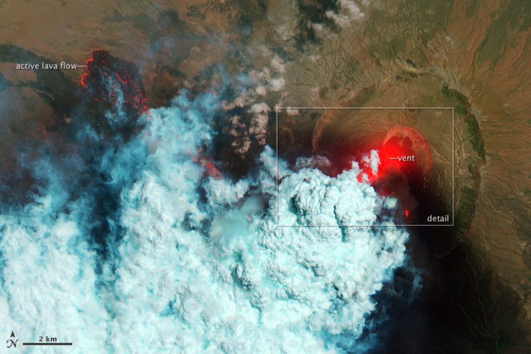 June 24: False-color image showing hot surfaces (bright red) with volcanic ash glowing above the vent in the center of Nabro's caldera, and portions of lava flowing to the west. The bulbous blue-white cloud is likely escaping water vapor that condensed as the plume rose and cooled. The wispy, cyan clouds above the lava flow are evidence of degassing from the lava. (NASA)