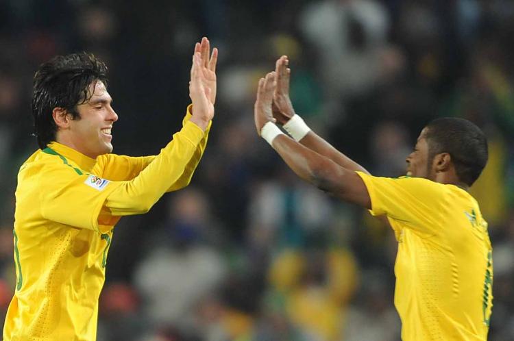 Kaka (L) and Michel Bastos celebrate a job well done as Brazil disposed of Chile on Monday. (Antonio Scorza/AFP/Getty Images)