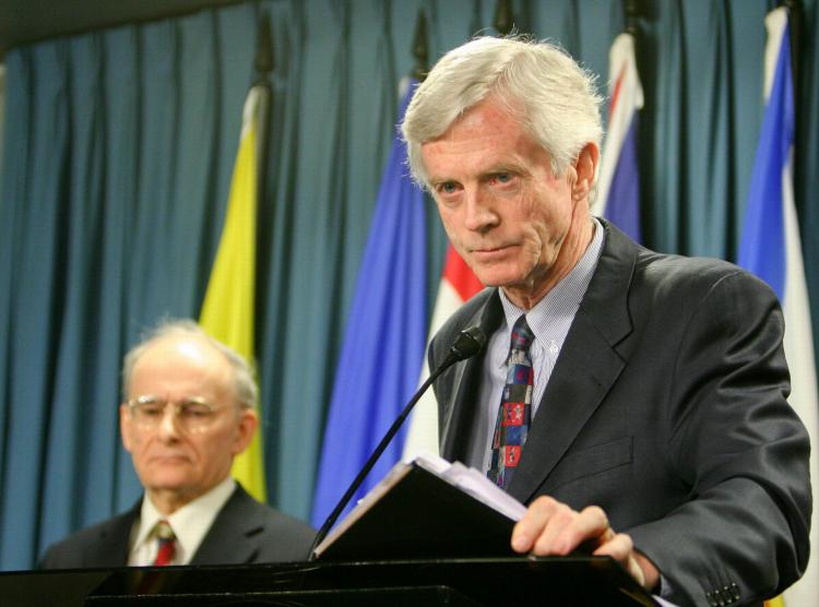 Former Canadian cabinet minister and Crown Prosecutor David Kilgour presents a revised report about the murder of Falun Gong practitioners in China for their organs, as report co-author lawyer David Matas listens in the background, on Jan. 31, 2007.  (Matthew Hildebrand/The Epoch Times )