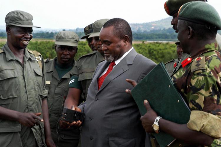 Luxury cars in the dozens were allegedly purchased by Uganda's Vice President Gilbert Bukenya, pictured center.  (Peter BusomokeAFP/Getty Images)