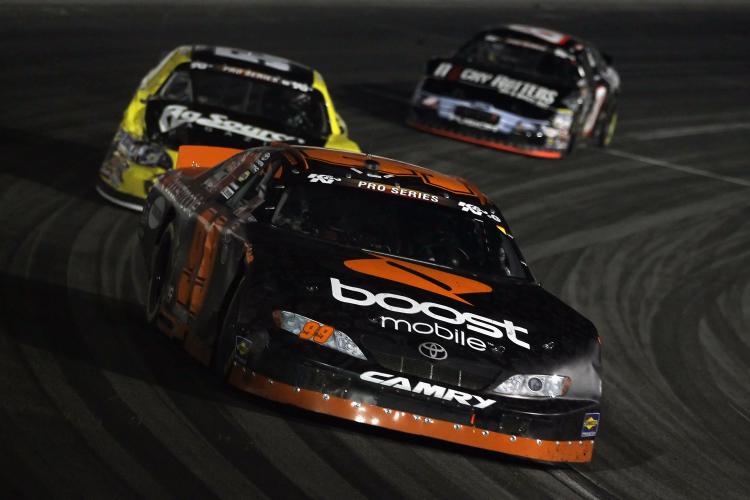 NASCAR: Travis Pastrana, driver of the #99 Boost Mobile Toyota, leads a pack of cars into a turn during the NASCAR Toyota All-Star Showdown at Toyota Speedway at Irwindale on Jan 29 in Irwindale, Calif. (Jeff Gross/Getty Images for NASCAR)