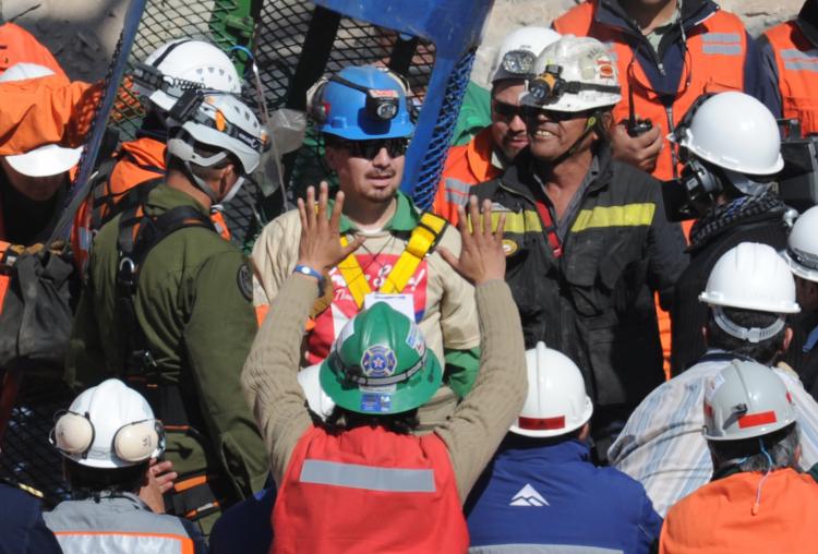 Oakley Radar-sporting Chilean miner Edison Pena (C) leaves the Fenix capsule after being brought to the surface in the twelfth place, on October 13, 2010. (Rodrigo Buendia/AFP/GETTY IMAGES)