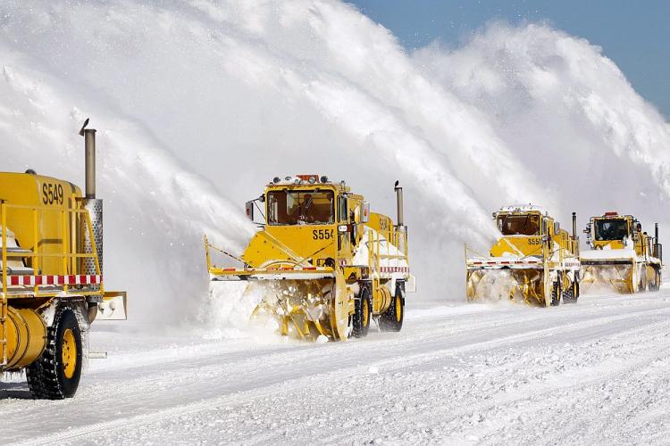 FLIGHTS RESUME: Workers remove snow from a runway at O'Hare International Airport on Feb. 3 in Chicago. Commercial carriers at the airport started flying on Thursday for the first time since a blizzard forced the grounding of almost all planes Tuesday afternoon. Throughout the city residents continue to dig out from more than 20 inches of snow that fell on the area Tuesday and Wednesday. (Scott Olson/Getty Images)