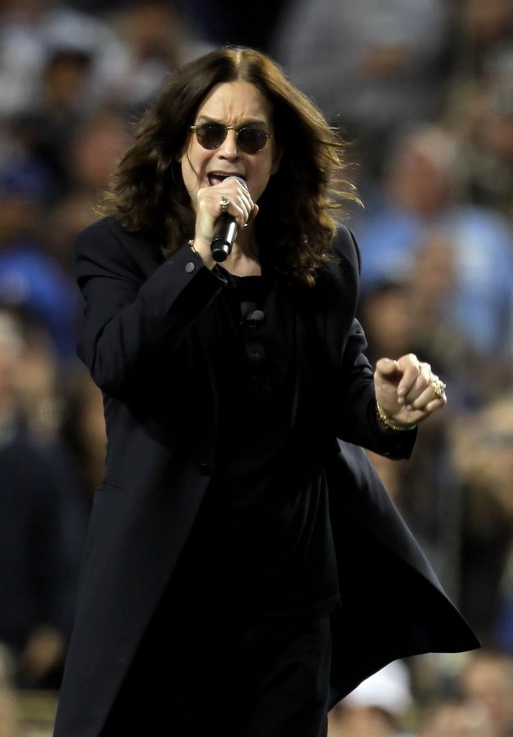 Ozzy Osbourne tries to lead the fans into the Guiness Book of World Records for the all-time loudest and longest scream, called 'Scream for a Cure,' at Dodger Stadium on June 11, in LA, California.  (Jeff Gross/Getty Images)