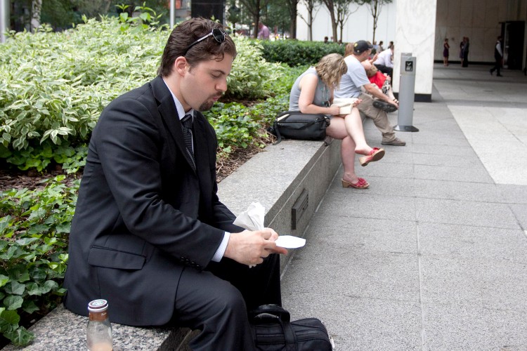 A PLACE TO REST: One Penn Plaza at 34th Street and Eighth Avenue is a privately owned public space. Local employees and pedestrians stop for a rest at lunch hour. (Tara MacIsaac/The Epoch Times)