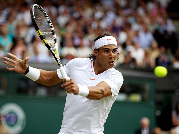 Rafael Nadalhits a backhand during his second round match against Robin Haase on Day Four of the Wimbledon Lawn Tennis Championships. (Clive Brunskill/Getty Images)