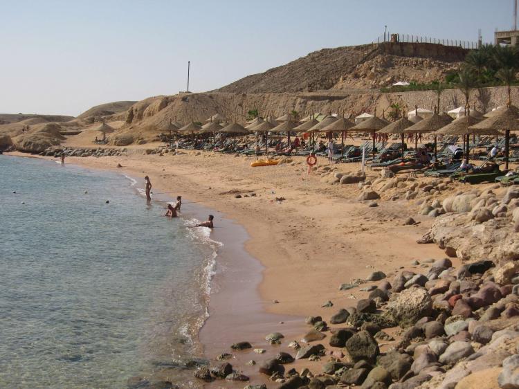 Tourists walk on the beach near the site in the Red Sea resort of Sharm el-Sheikh on December 6, 2010. (Khaled Desouki/AFP/Getty Images)