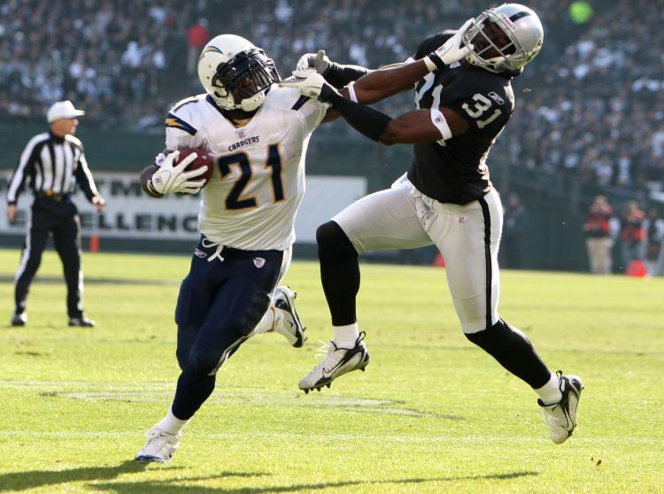 STIFF ARM: San Diego's LaDainian Tomlinson has had some memorable games against the Oakland Raiders in recent seasons. (Jed Jacobsohn/Getty Images)