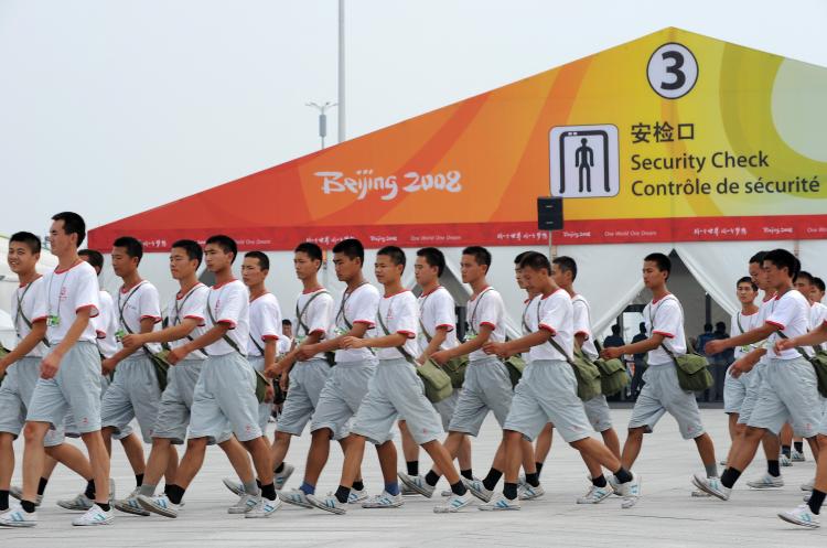 Chinese security personnel march towards the National Stadium, also known as the 'Birds Nest' in Beijing, on August 5, 2008.  (Christophe Simon/AFP/Getty Images)