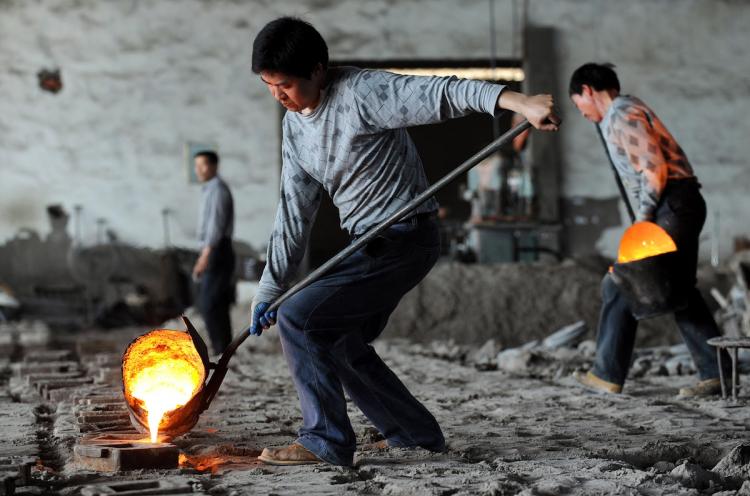 Chinese workers pour molten steel into the casters at a small iron and steel mill in central China's Anhui province. Anshan Iron & Steel Group, China's fourth-largest steel maker, has not warm welcoming in attempting to build steel plants in the US.   (STR/Getty Images)