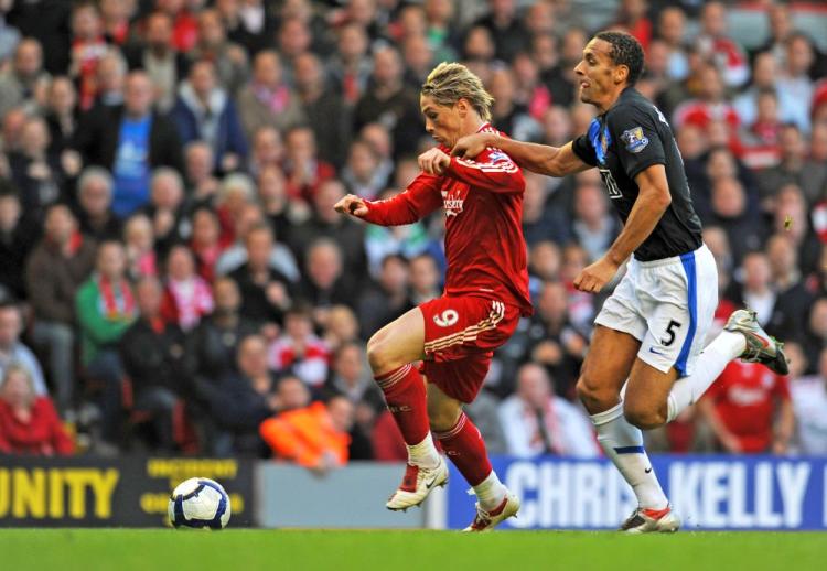 Liverpool‘s Fernando Torres (left) pulls away from Manchester United‘s Rio Ferdinand to score the game‘s opening goal. (Paul Ellis/AFP/Getty Images)