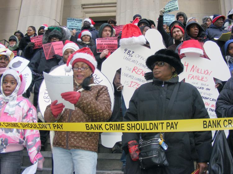 Protesters rallied on Wall Street against an estimated $143 billion worth of bonus packages to bank executives. Desiree Pilgram-Hunter (R, in black coat), whose family has been greatly impacted by the financial crisis, was among the protesters. (Gidon Belmaker/ The Epoch Times)