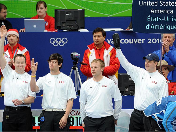 U.S. curling team members (L-R), John Benton, Chris Plys, Jeff Isaacson and John Shuster wave prior to their Vancouver Winter Olympics men's curling round against China. (Toshifumi Kitamura/AFP/Getty Images)