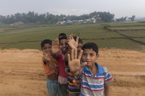 Children wave at the camera in Lombashia Camp, Coxâz Bazar, Bangladesh, on May 19, 2018. (Aungmakhai Chak/DEC)
