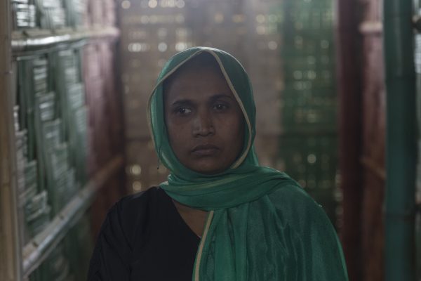 Nur Halima, 35, poses for a portrait inside a CARE-provided women-friendly space, in Potibunia camp, Bagladesh, on May 18, 2018. Nur Halima and her family of seven hid for ten days in a forest before they were able to escape. (Aungmakhai Chak/DEC)