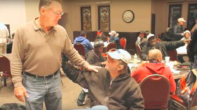 Bross greets someone at City Church breakfast.