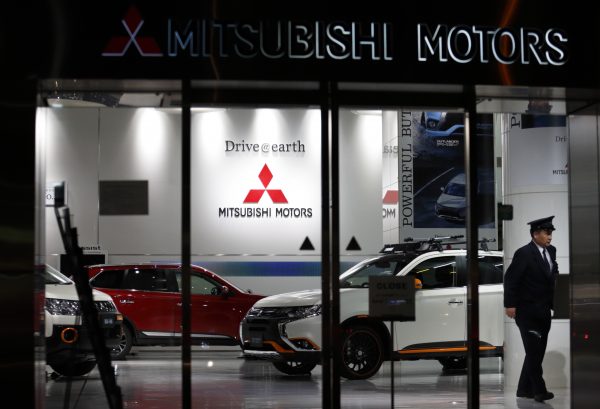 security worker walks past Mitsubishi