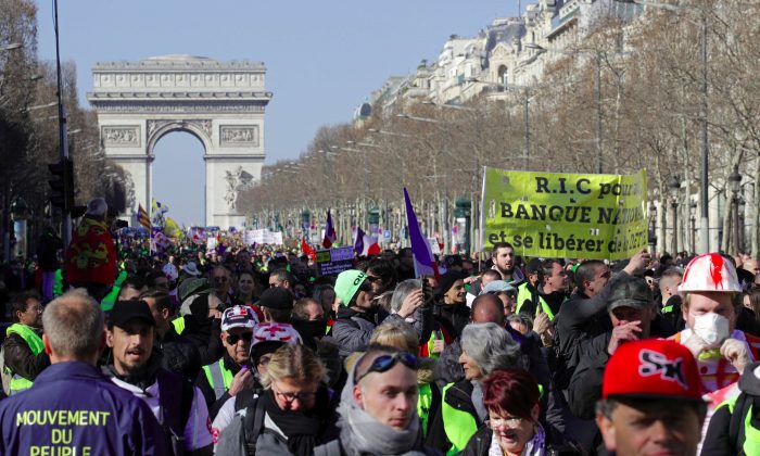 Protesters wearing yellow vests march down the Champs Elysees in Paris on Feb. 23, 2019. (Philippe Wojazer/Reuters)