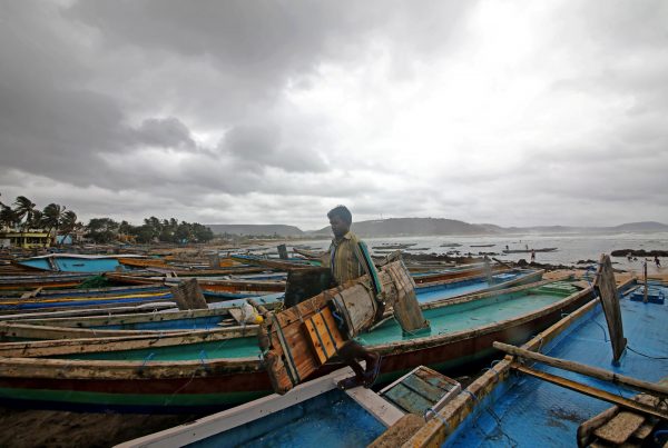 A fisherman carries his tools