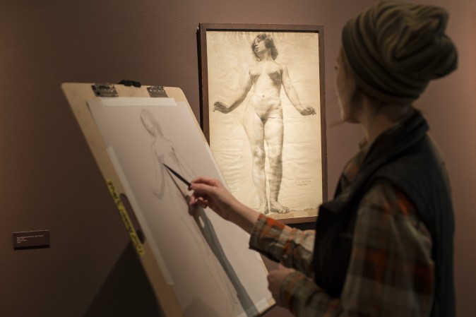 A student copies a drawing displayed in the "Drawn to Life" exhibit at the Florence Academy of Art-U.S. Branch in Jersey City, N. J., on Feb. 28, 2017. (Samira Bouaou/Epoch Times)