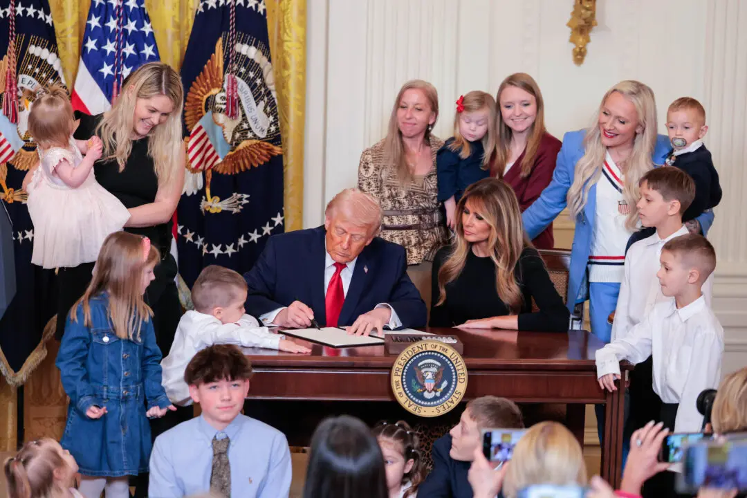 President Donald Trump signs a proclamation for Women's History Month with first lady Melania Trump during an event in the East Room of the White House on March 12, 2026. The United States has observed Women's History Month in March since 1987. (Heather Diehl/Getty Images)