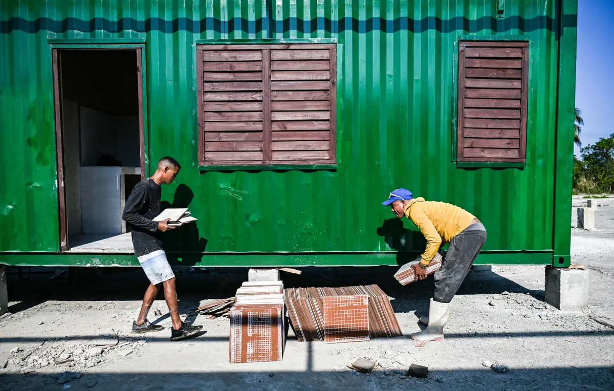 Day in Photos: Shipping Containers Housing, Mail Carriers’ Strike, and ISIS-Linked Women Returning to Australia