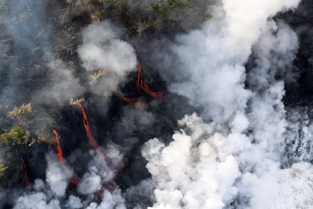 An aerial picture shows lava from the Piton de la Fournaise volcano reaching the ocean in Sainte-Rose, on the French Indian ocean island of Reunion, on March 16, 2026. (Richard BOUHET / AFP via Getty Images)