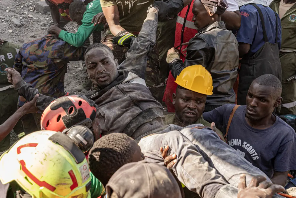 Rescuers carry an injured man away from the scene where a building collapsed in the Blue Estate area of Shauri Moyo in Nairobi, Kenya, on March 16, 2026. (SIMON MAINA / AFP via Getty Images)