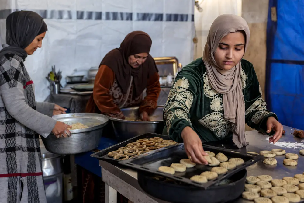 Women prepare ring-shaped traditional "kaak" biscuits ahead of Eid al-Fitr, the holiday marking the end of the Muslim holy fasting month of Ramadan, in Gaza City on March 16, 2026. (Omar Al Qattaa/ AFP via Getty Images)